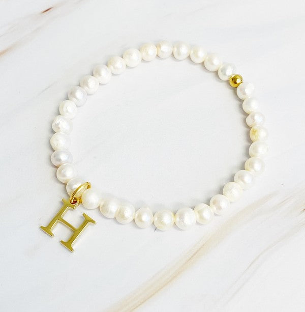 Freshwater Pearl Initial Charm Bracelet featuring genuine freshwater pearls and a gold-plated letter H initial charm, approximately 6.5" before stretch.