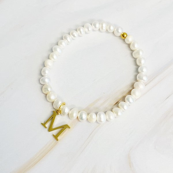 Freshwater Pearl Initial Charm Bracelet featuring genuine freshwater pearls and a gold-plated letter M initial charm, approximately 6.5" before stretch.