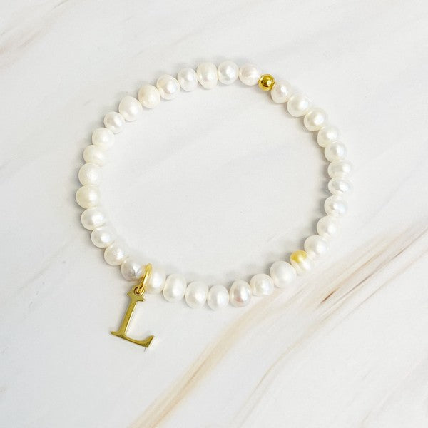 Freshwater Pearl Initial Charm Bracelet featuring genuine freshwater pearls and a gold-plated letter L initial charm, approximately 6.5" before stretch.