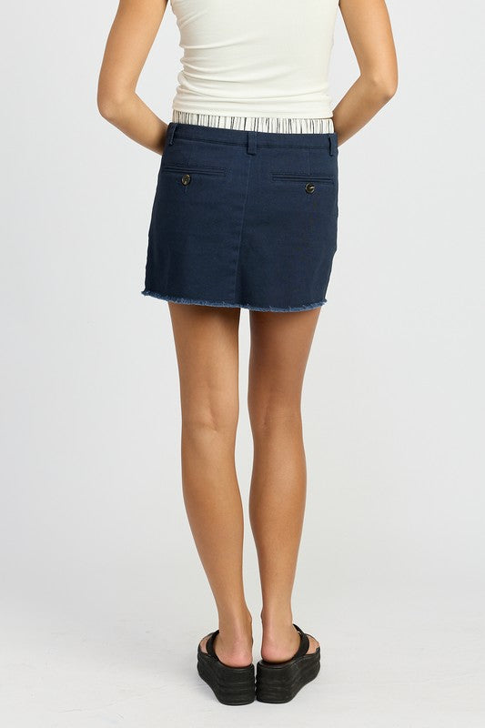 Navy mini skirt with striped double waistband, mid-rise, and a playful, retro style.