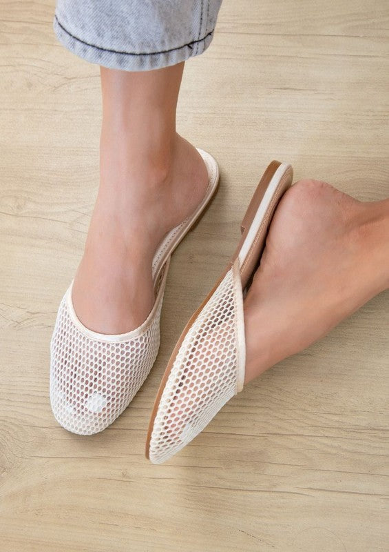 Model in champagne Levi slip-on mesh flats, flat heel, round toe, open back for casual elegance.
