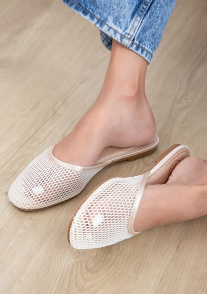 Woman wearing champagne Levi mesh ballerina flats, perfect for fashionable summer wear.