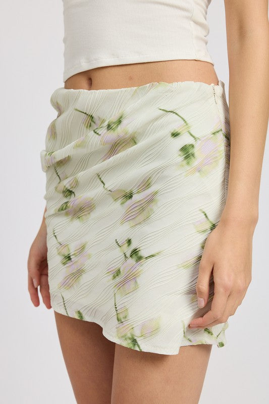 Ivory floral pencil skirt with side slit, mid-rise waist, and mini length. Chic and versatile for casual to evening wear.