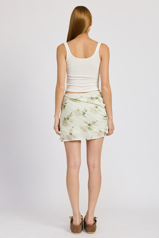 Ivory floral pencil skirt with side slit, mid-rise waist, and mini length. Chic and versatile for casual to evening wear.