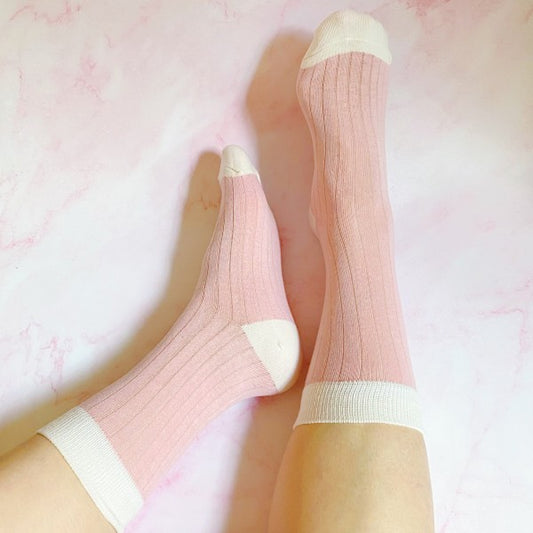 Woman wearing pink Silky Jacquard Socks with white trim detail and silky lightweight finish.