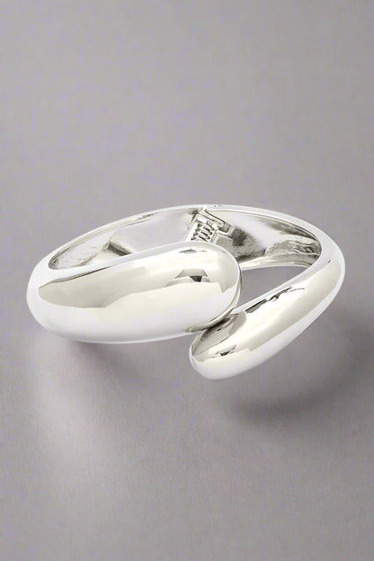 Polished Organic Hinged Bangle in silver, front view showing sculptural organic design.