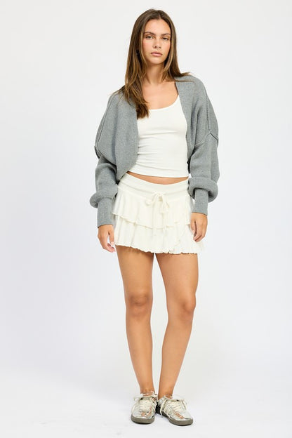 Full body look of Jericha Shrug Cardigan in gray layered over white tank