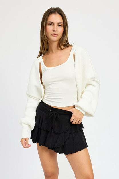 Jericha Oversized Shrug Cardigan in off white layered over tank and skirt