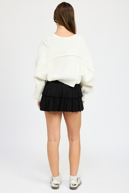Back view of Jericha Shrug Cardigan in off white showing oversized style