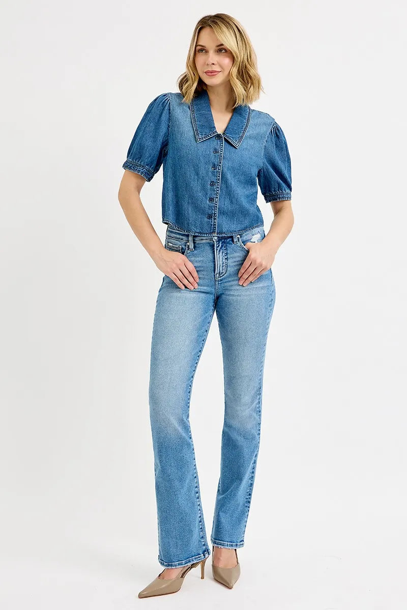 Model wearing Alexa cropped puff sleeve denim shirt styled with high-waisted pants.