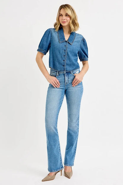 Model wearing Alexa cropped puff sleeve denim shirt styled with high-waisted pants.