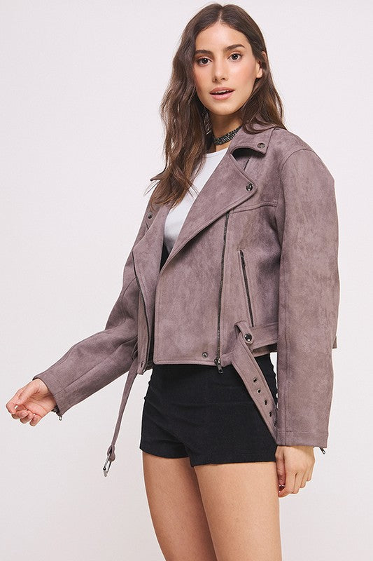 Grey belted long sleeve zippered suede moto jacket with front zippers, snap details, and two zipper pockets.