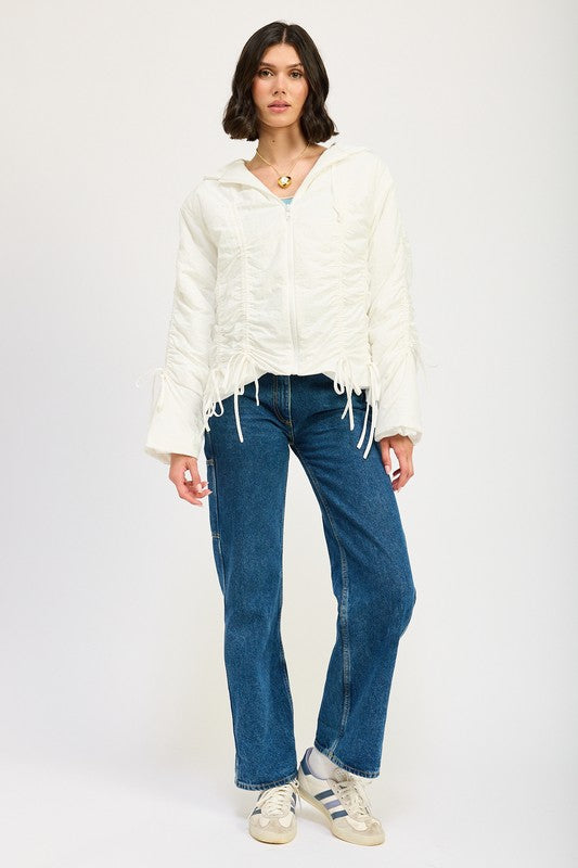 Full body view of model styling ivory Candes Ruched Puff Jacket