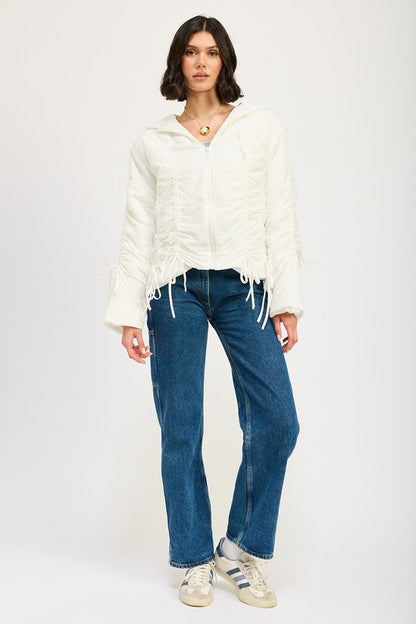 Full body view of model styling ivory Candes Ruched Puff Jacket