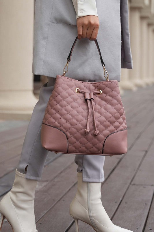 Model carrying Mauve Wendy Bucket Bag styled with neutral outfit for a chic look.
