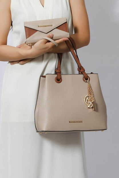 Woman holding taupe Kearny tote and wallet.