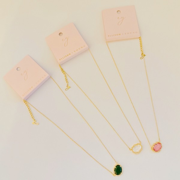 Gold-plated necklaces with clustered emerald, clear, and pink glass jewels, approximately 15 inches long with a 2.5-inch extender.