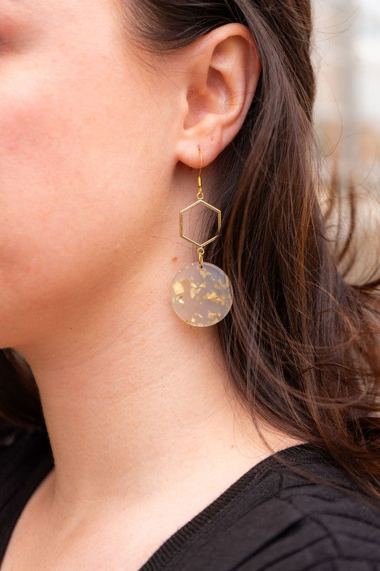 Woman wearing Layla Hexagon Acrylic Drop Earrings with gold hexagon charms and lightweight acrylic, modern geometric design. 