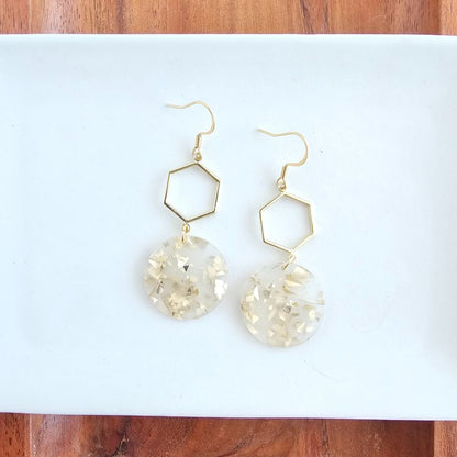 air of Layla Hexagon Acrylic Drop Earrings displayed on white background with gold hexagon charms and sleek acrylic drops. 