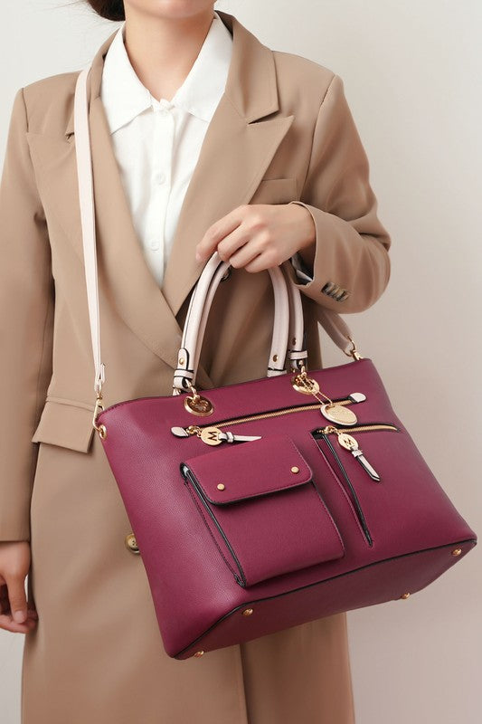 A trendy look featuring the Julia Satchel worn with the adjustable strap as a crossbody, emphasizing its versatility and comfortable fit.