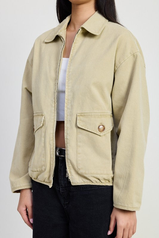 Close up of Aylin Collared Denim Jacket in sand highlighting zipper and pocket details