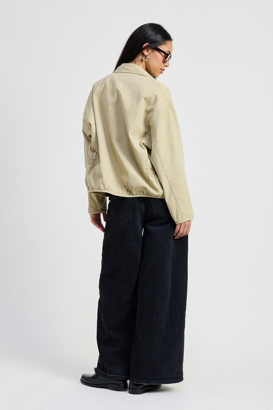 Back view of Aylin Sand Denim Jacket with collared design and relaxed long sleeve fit