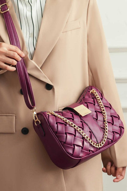 Woman wearing burgundy Solari Braided Chain Shoulder Bag crossbody style with woven exterior and braided chain strap.