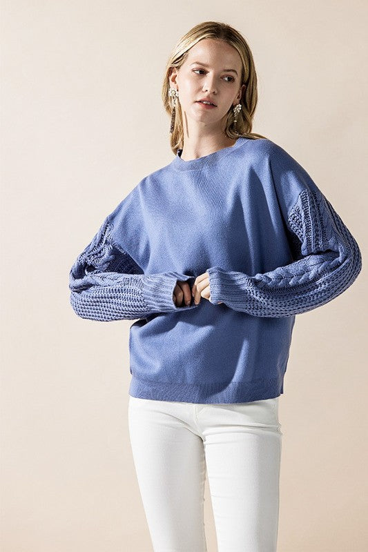 Casual denim blue Jodie sweater styled with white pants