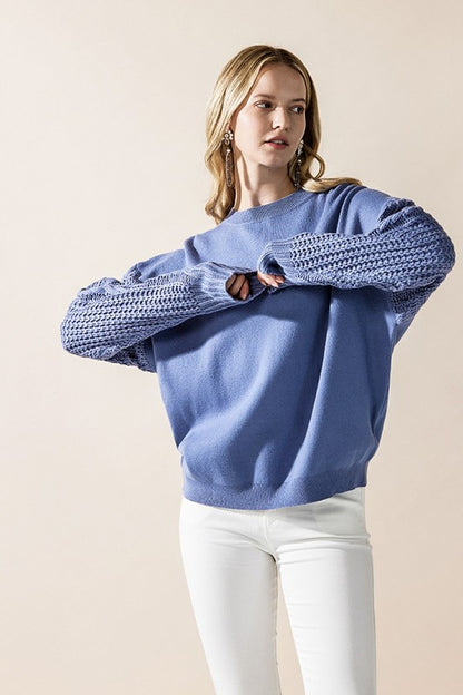 Relaxed fit denim blue sweater with cable knit sleeves