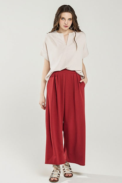 Ember Plus Size Crepe Wide Leg Pants in cognac front view tucked waistline