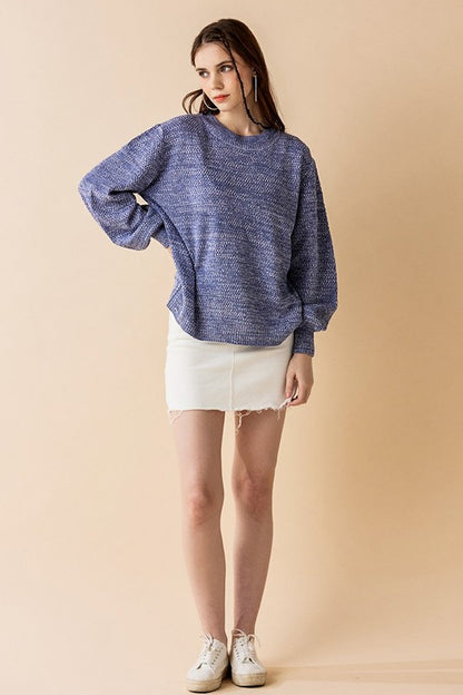 Woman in Denim round neck relaxed fit sweater knit.