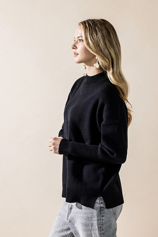 Black Danika Mock Neck Sweater side angle highlighting side slit