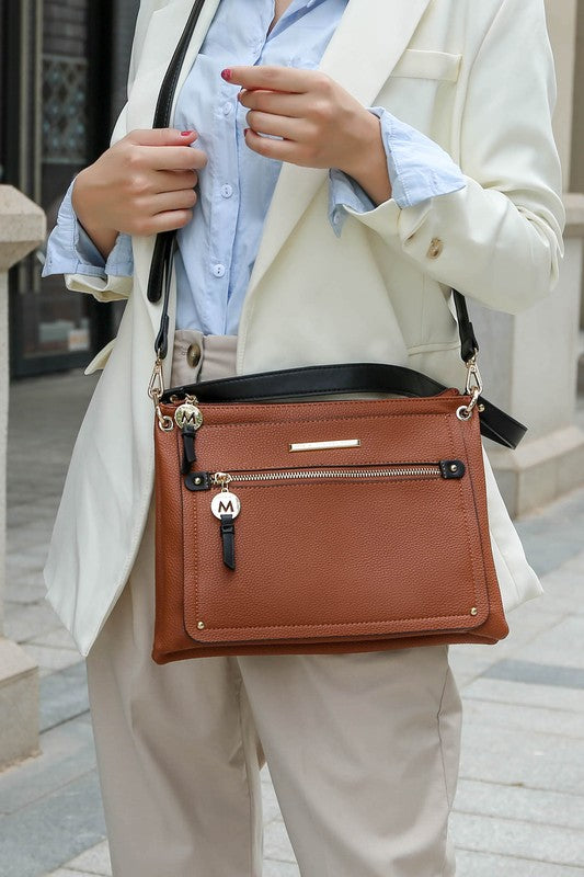 Woman wearing cognac/black Aliyah shoulder bag crossbody style.