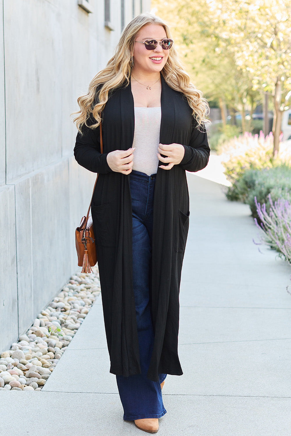 Black open-front long-sleeve cover-up with a flowy design and pockets, perfect for layering on breezy days.