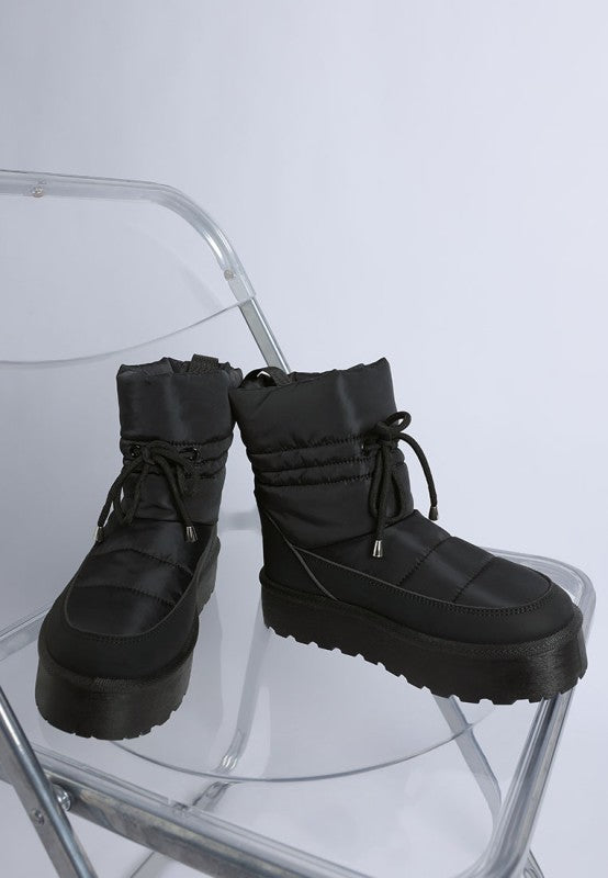 Black Pacos Snow Boots showing medial side of both shoes, lace-up detail.