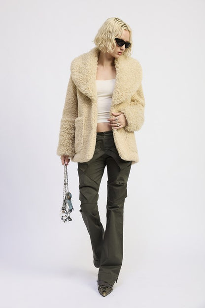 Full body view of Zephyr Fleece Jacket in taupe styled with pants and handbag