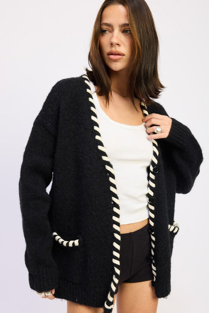 Front view of Londyn Trim Cardigan styled open over a white tank top