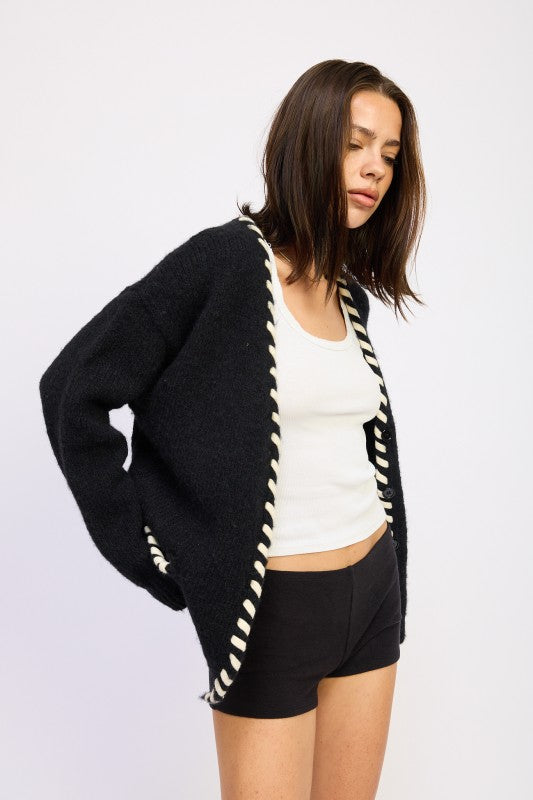 Side view of Londyn Trim Cardigan in black showing contrasting trim detail