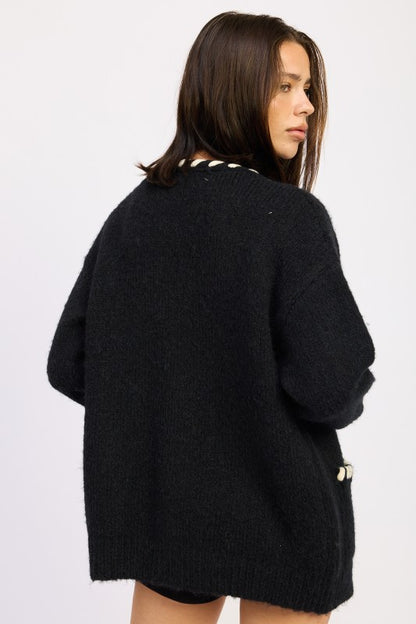 Back view of Londyn Trim Cardigan in black knit with relaxed silhouette