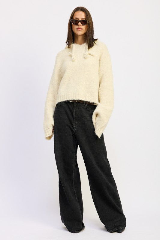 Ivory Juniper Fringe Hoodie full body with wide-leg black denim