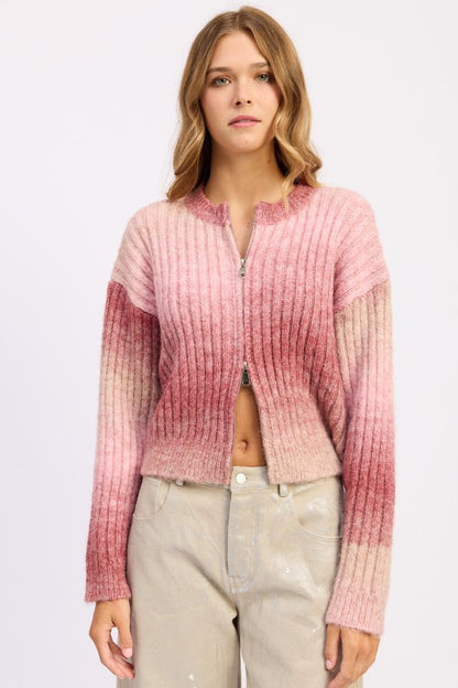 Model wearing Lexi Ribbed Cardigan in rose ombré, front view showing zipper detail.