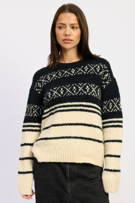 Woman wearing Adaline Fair Isle Striped Oversized Sweater in black cream, front view long sleeve knit.
