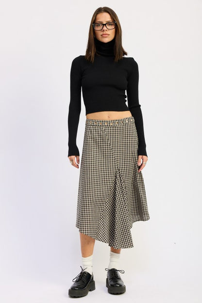 Full body front view of model wearing Karrigan Asymmetrical Skirt in black and beige gingham.