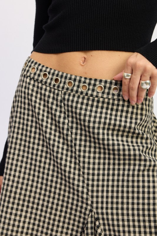 Close up of Karrigan Skirt waistband highlighting grommet and gingham pattern.