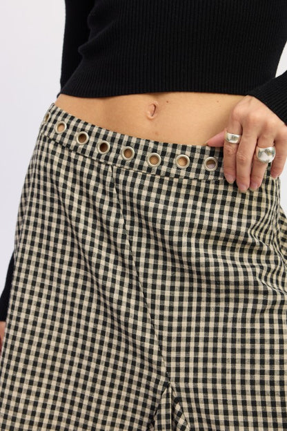 Close up of Karrigan Skirt waistband highlighting grommet and gingham pattern.