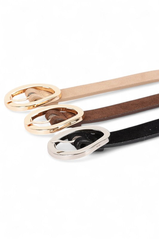 Flat lay of Elora 3-in-1 Skinny Belt Set in tan, brown, and black faux suede with metallic buckles.