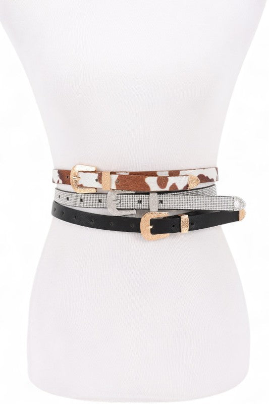 Front view of Dhara 3-in-1 Skinny Belt Set on mannequin with black, silver, and cowhide belts.
