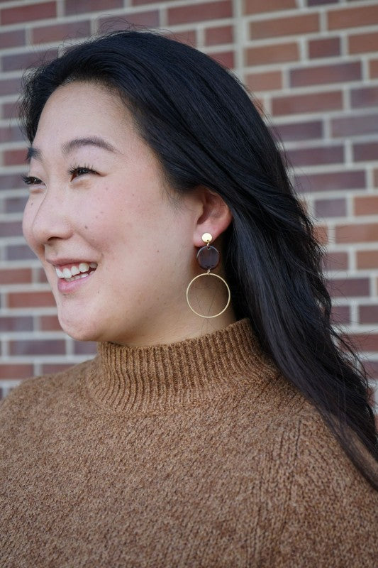Sadie Earrings in Walnut worn on ear with stainless steel post and hoop dangle with walnut acrylic charm