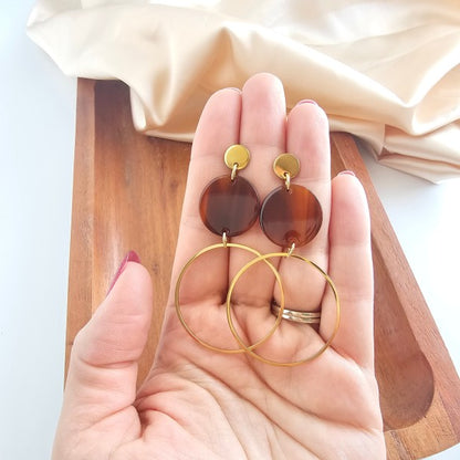 Hand holding Sadie Earrings in Walnut to show size, gold plated hoop and walnut acrylic disc detail
