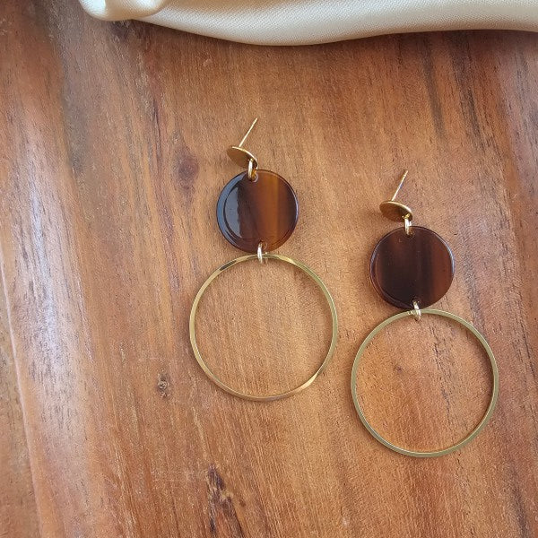 Flat lay of Sadie Earrings in Walnut with glossy walnut acrylic discs and 18k gold plated hoops